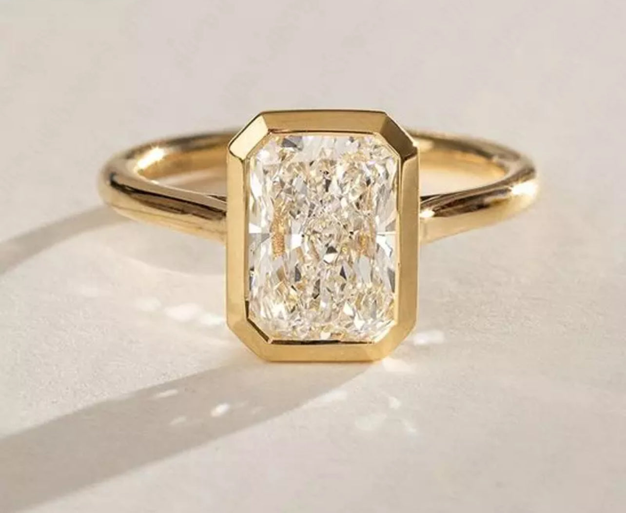 3 Carat Radiant Cut with a solitaire band and bezel setting