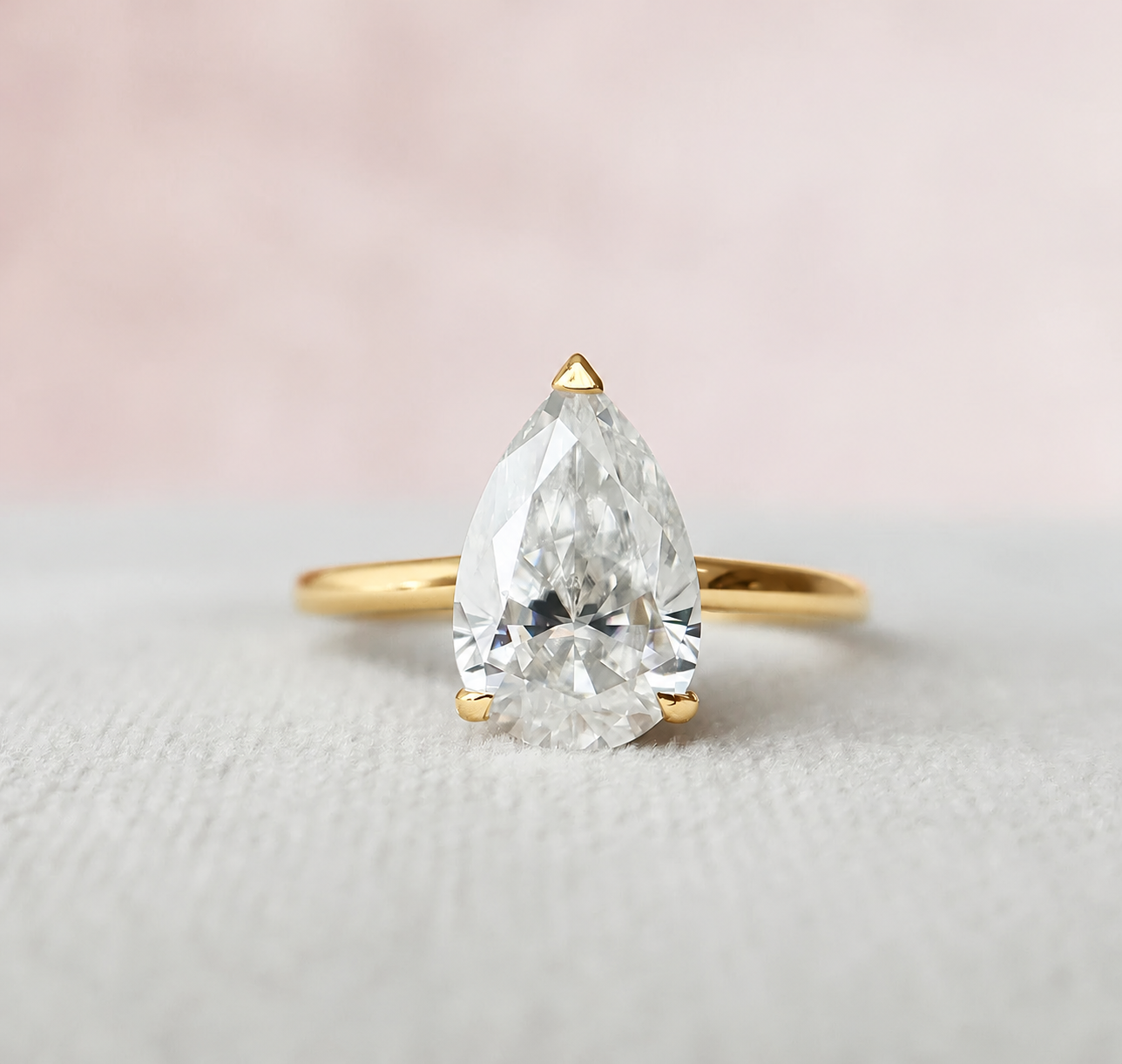 3 Carat Pear Cut with a Solitaire Band, Hidden Halo and Shoulder Accents in yellow gold